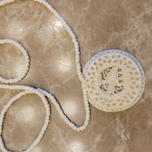 Authentic hand-carved East Indian beaded ivory-colored necklace, 9" drop.